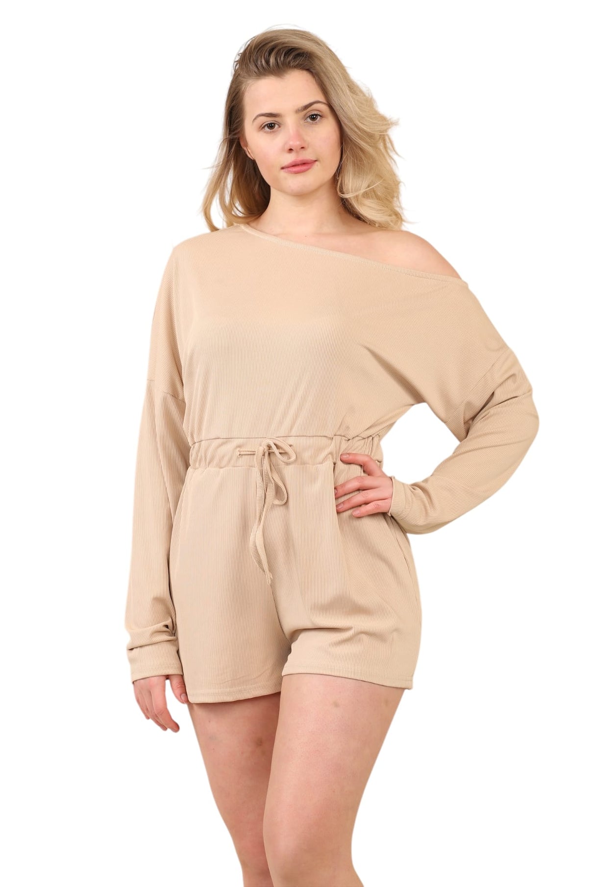 Woman wearing a beige romper on a white background