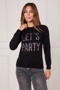 Woman wearing a black sweater with 'LET'S PARTY' text in colorful letters against a white background