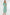Woman wearing a green floral dress on a white background