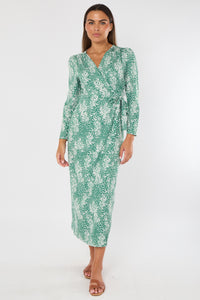 Woman wearing a green floral dress on a white background