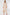 Woman wearing a beige ribbed dress on a white background