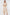Woman wearing a beige wrap dress on a white background