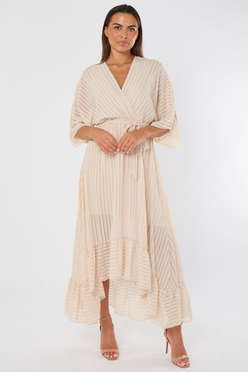 Woman wearing a beige wrap dress on a white background