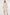 Woman wearing a beige ribbed dress on a white background