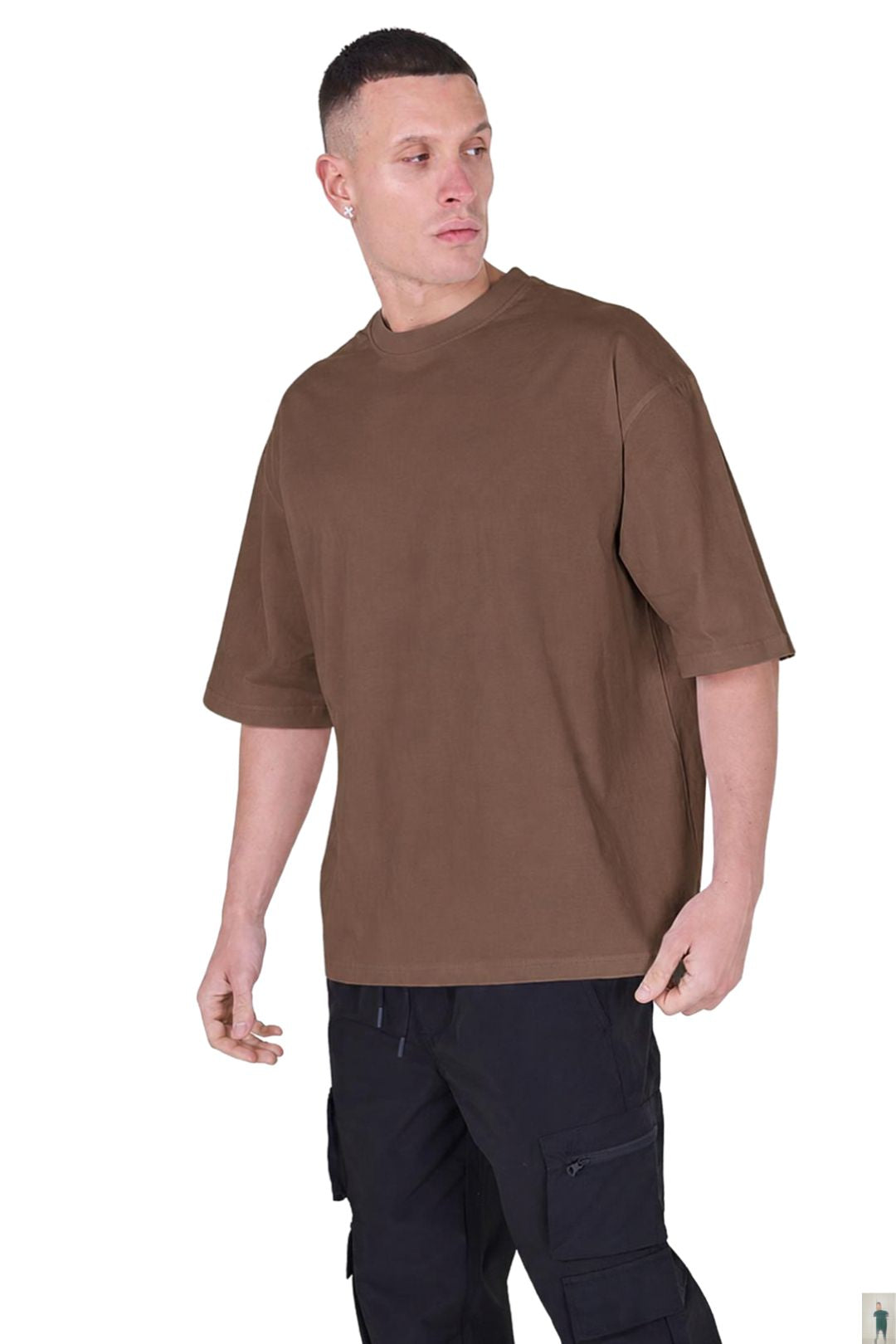 A man wearing a brown short-sleeve crewneck t-shirt and black cargo pants, standing against a plain white background.
