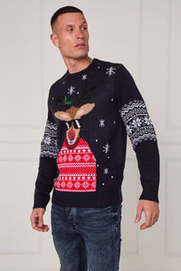 Man wearing a black Christmas sweater with reindeer design against a white background