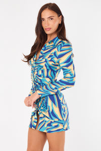 Woman wearing a blue and yellow patterned dress on a white background