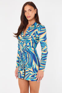 Woman wearing a colorful patterned dress on a white background