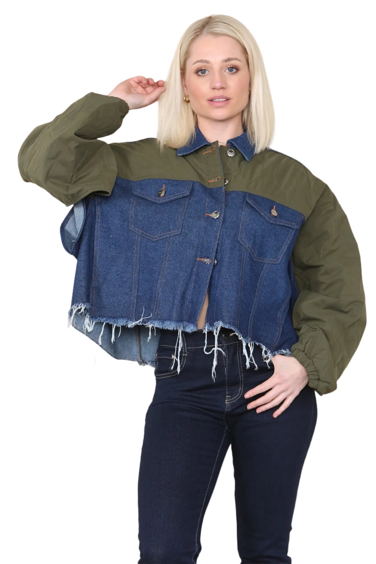 Woman wearing a two-tone jacket with green sleeves and blue denim front on a beige background
