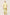 Woman wearing a light yellow satin pyjama set with short sleeves and long trousers, featuring dark-coloured piping details, standing against a neutral background