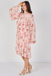 Woman wearing a pink floral dress against a white background