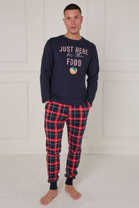 Man wearing navy sweatshirt with text and plaid pants on a white background